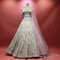 Ivory floral embroidered lehenga with scalloped hem and pink net dupatta