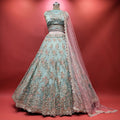 Sky blue lehenga with dense floral resham and cutdana embroidery, pink sheer dupatta