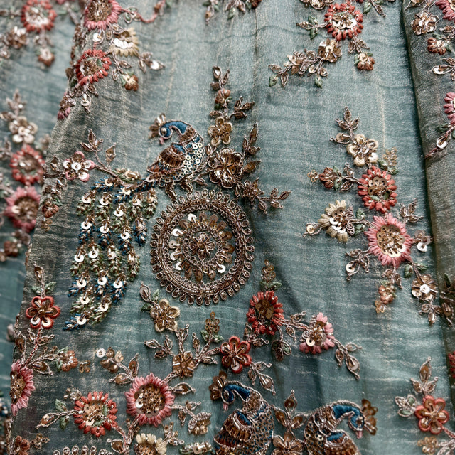 Close-up of sky blue fabric with multicolor floral resham and cutdana embroidery