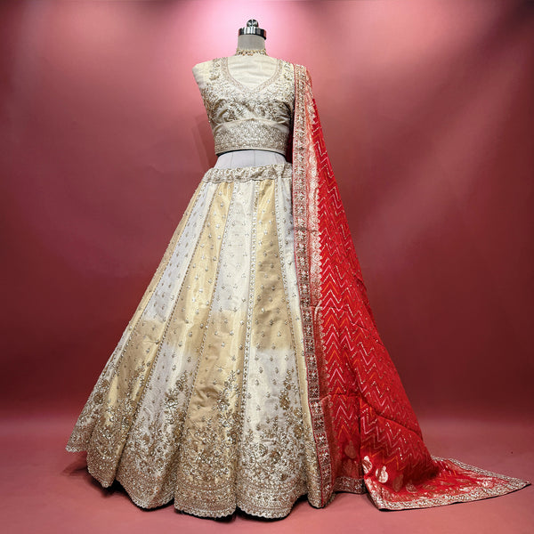 Ivory gold raw silk lehenga with silver motifs and red bandhej dupatta