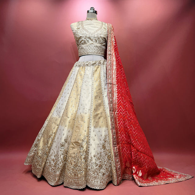 Ivory gold raw silk lehenga with silver motifs and red bandhej dupatta