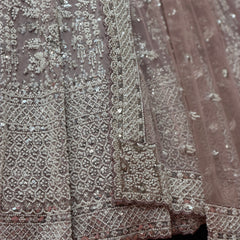 Close-up of lavender beaded embroidery on lehenga with sparkling floral-vine pattern