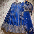 Royal blue embroidered lehenga with full sleeves, ornate hem border and matching dupatta