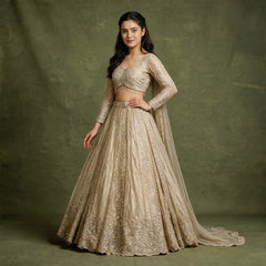 Embroidered gold lehenga with long-sleeve stitched blouse and flared skirt