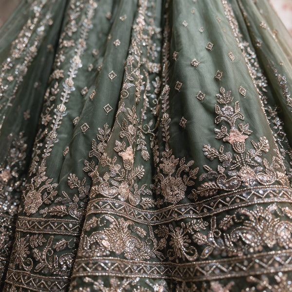 Olive lehenga skirt closeup with cutdana and floral sequin embroidery, tiered hem border