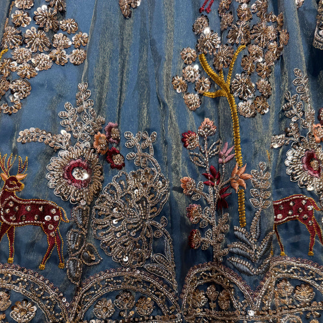 Blue lehenga with gold, red, and multicolor hand embroidery detail on tissue silk