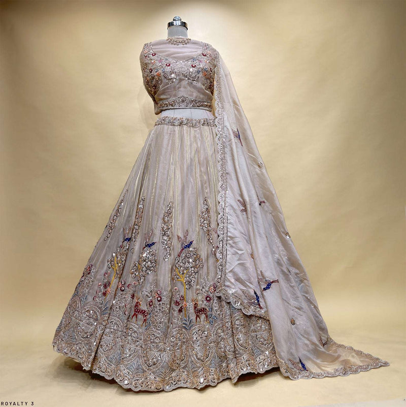 Embroidered lehenga with full-sleeve blouse on mannequin, light beige skirt with silver border