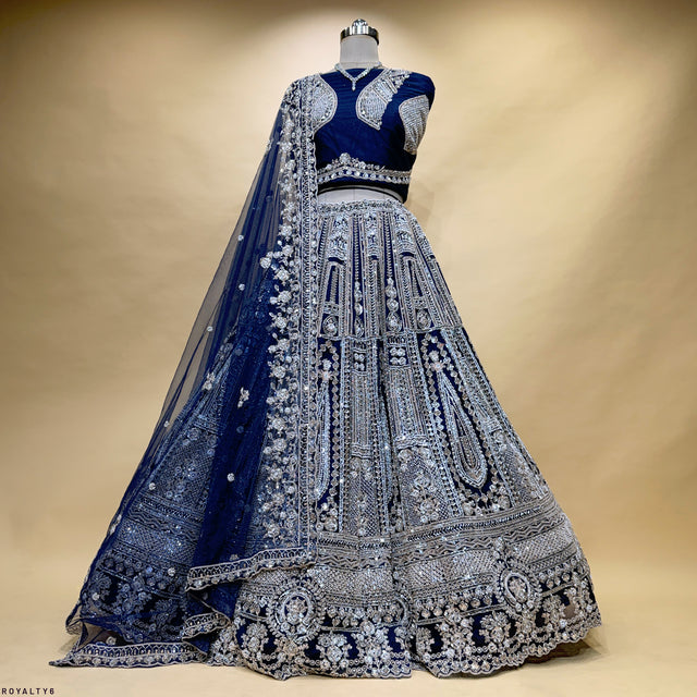 Navy blue embroidered lehenga with silver-toned yoke blouse and net dupatta