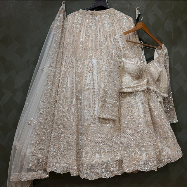 Pearl-white embroidered lehenga skirt with matching blouse and sheer dupatta
