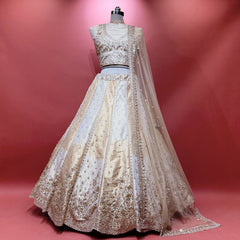Offwhite gold embellished lehenga with sheer net dupatta and cutdana-style work