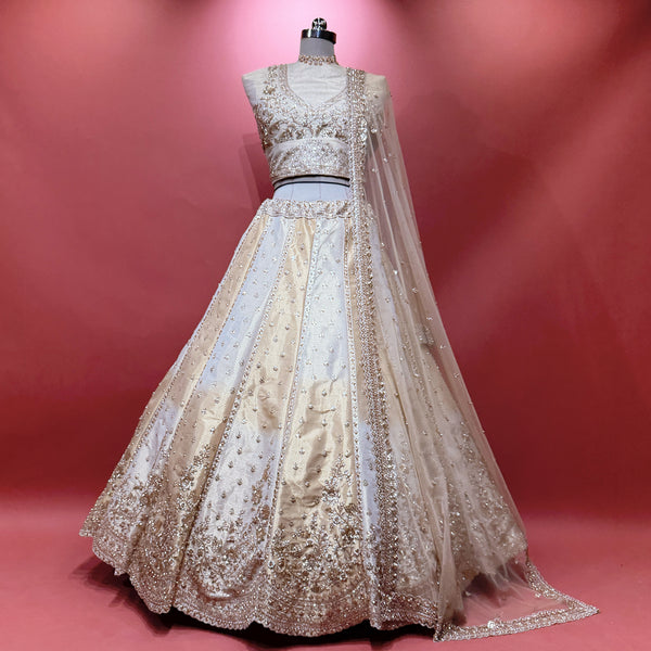 Offwhite gold embellished lehenga with sheer net dupatta and cutdana-style work