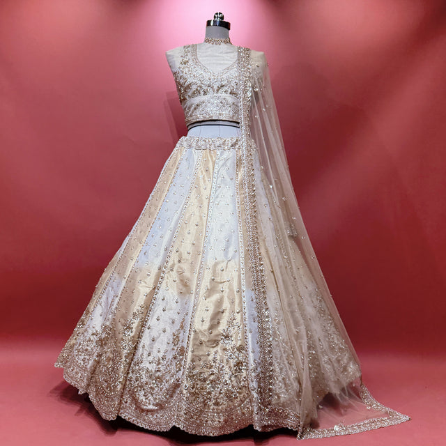 Offwhite gold embellished lehenga with sheer net dupatta and cutdana-style work