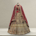 Maroon and gold bridal lehenga with layered dupattas, ornate embroidered bodice and skirt