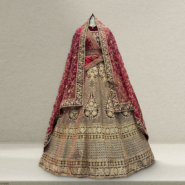 Maroon and gold bridal lehenga with layered dupattas, ornate embroidered bodice and skirt