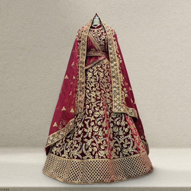 Maroon velvet bridal lehenga with gold embroidered skirt and matching dupatta