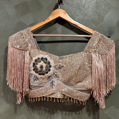 Champagne sequin saree with cut dana work, floral motif and tassel fringe detailing