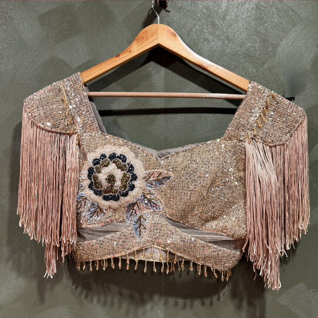 Champagne sequin saree with cut dana work, floral motif and tassel fringe detailing