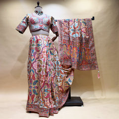 Ivory multicolour paisley print saree set on mannequin with embroidered border