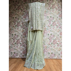 Mint green georgette saree with silver resham border and pallu