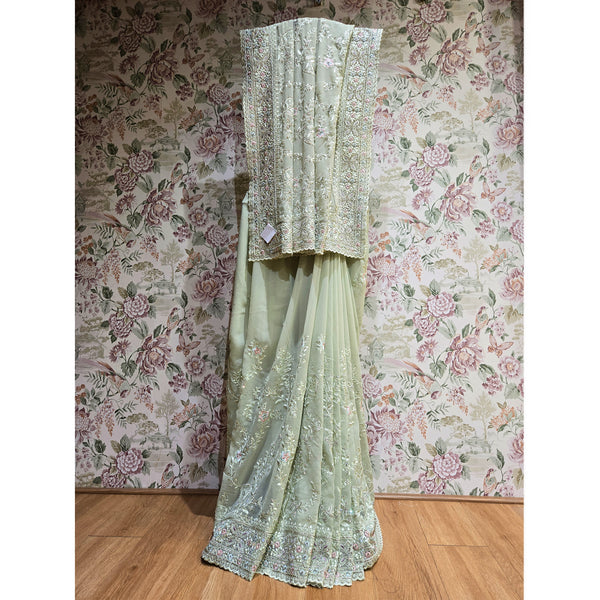 Mint green georgette saree with silver resham border and pallu