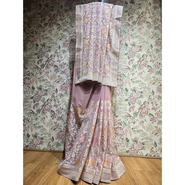 Lilac georgette saree with resham floral vine print and gold border, draped
