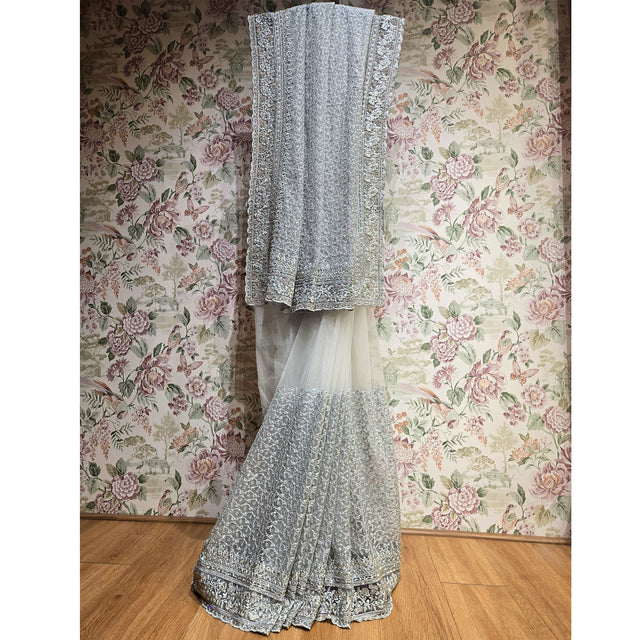 Ivory net saree with scalloped silver stone border, draped vertically