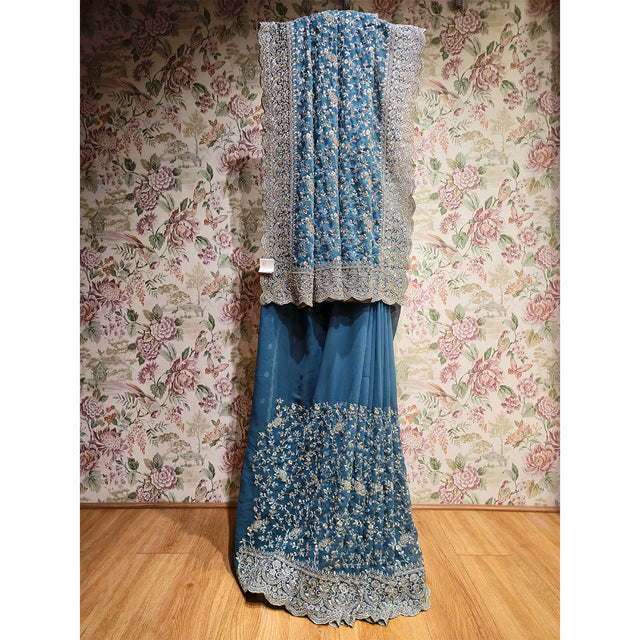 Teal georgette saree with silver floral stone work and lace border