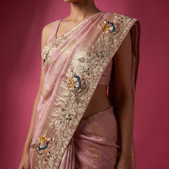 Blush pink saree pallu with ornate gold embroidery and colored bird motif