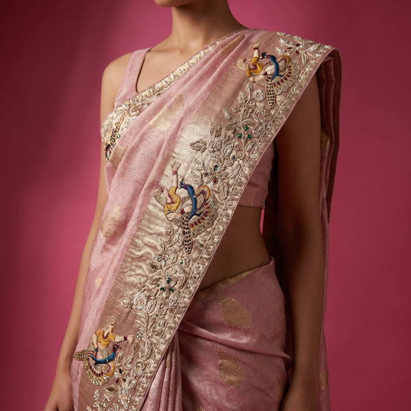 Blush pink saree pallu with ornate gold embroidery and colored bird motif