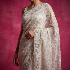 Ivory net saree with tonal thread embroidery on draped pallu