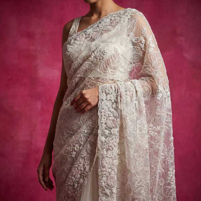 Ivory net saree with tonal thread embroidery on draped pallu