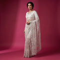Ivory net saree with tonal thread floral embroidery and scalloped border