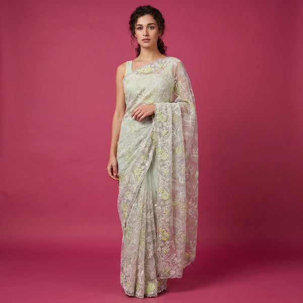 Ivory net saree with pale green thread embroidery and floral motifs