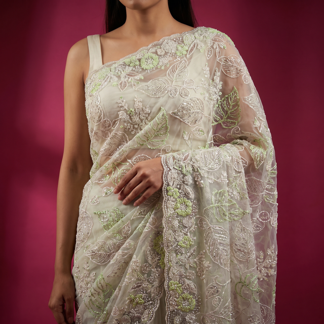 Ivory net saree with pale green thread embroidery on sheer pallu, leaf and vine details