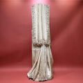 Ivory viscose silk saree with embroidered vertical motifs and tassel-edged border