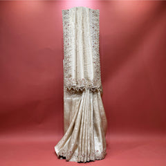 Ivory viscose silk saree with embroidered vertical motifs and tassel-edged border