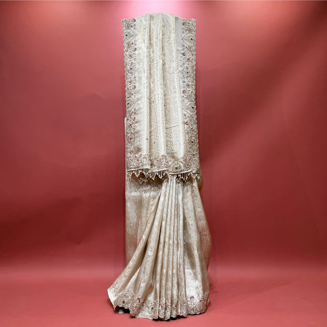 Ivory viscose silk saree with embroidered vertical motifs and tassel-edged border