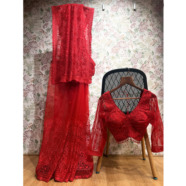Red net saree with dhaga and stone work; matching stitched red blouse with lace trim