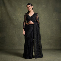 Black net cocktail saree with draped pallu and full-sleeve stitched blouse, stitched details