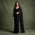 Black net cocktail saree with beaded full-sleeve blouse, draped side and sheer border