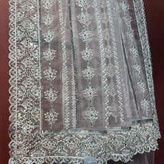 Blush pink net saree with silver moti and sequin vertical motifs and scalloped border