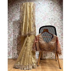 Gold tissue silk saree set with ornate cut-dana work and stitched blouse
