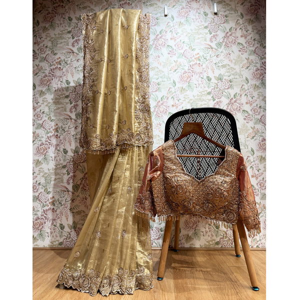 Gold tissue silk saree set with ornate cut-dana work and stitched blouse