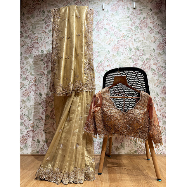 Gold tissue silk saree set with ornate cut-dana work and stitched blouse