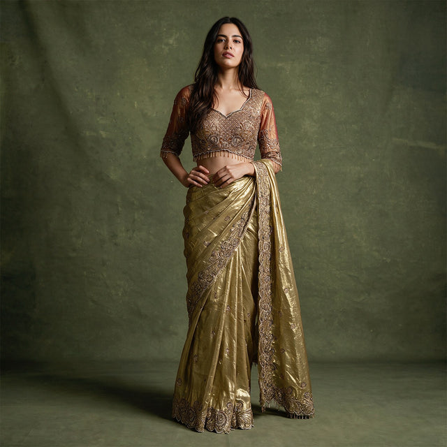Gold viscose tissue saree with cut dana work and stitched blouse, ornate border and pallu