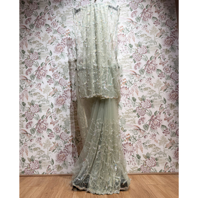 Sage green net saree with sequin lattice and cut dana, layered border drape.
