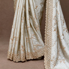 Close-up of honeycomb weave, gold vine handwork and scalloped border on ivory crepe silk
