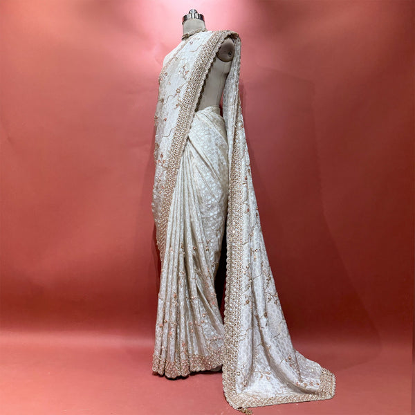Ivory honeycomb crepe silk saree with gold handwork border on mannequin