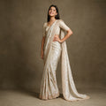 Ivory honeycomb crepe silk saree with gold handwork border and heavy handwork blouse, worn