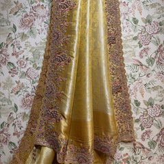 Gold Kanjivaram saree with resham and zari border draped on hanger